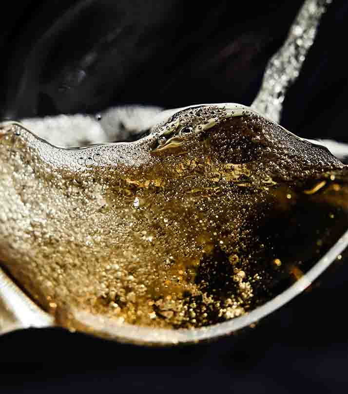 White,Wine,Being,Poured,Into,A,Wineglass.